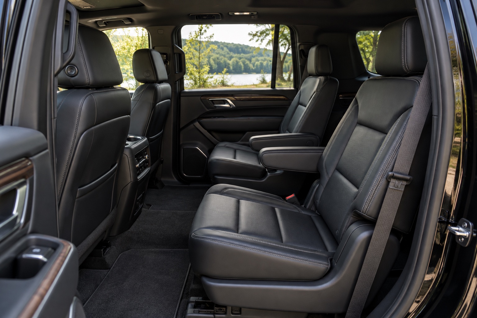 Spacious black leather passenger seating inside a large SUV